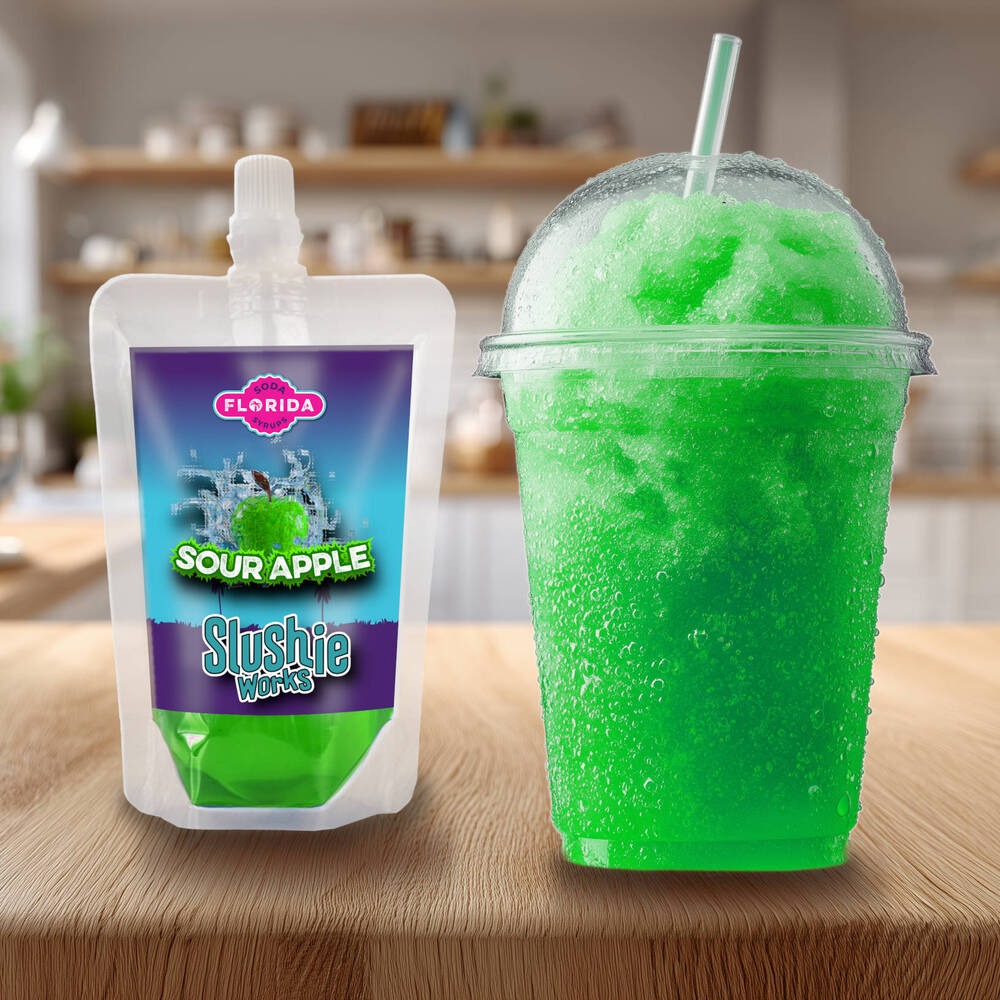 Sour Apple Flavour Ninja Slushi Slush Pack on the left with a blue slush drink on the right