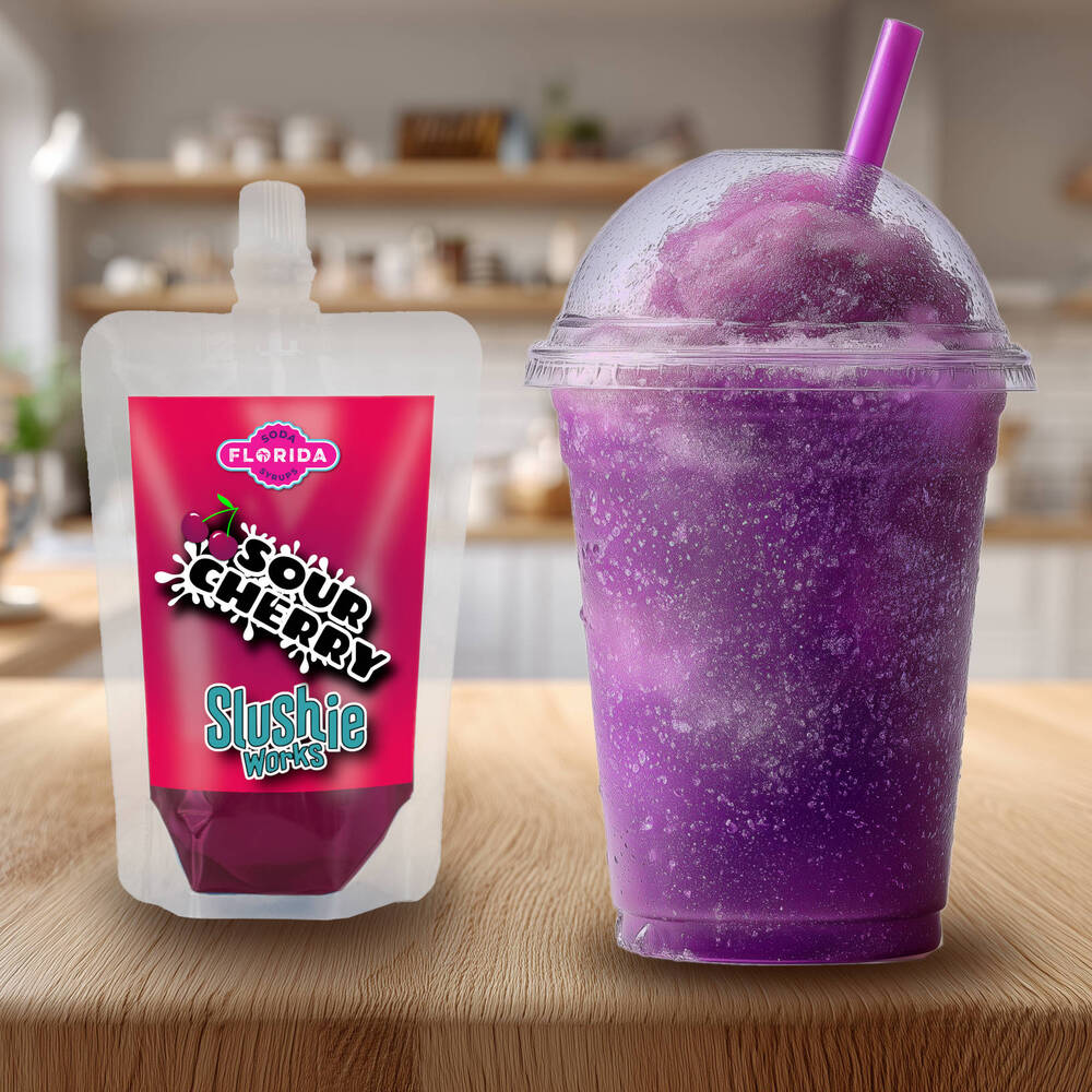 Sour Cherry Flavour Ninja Slushi Slush Pack on the left with a blue slush drink on the right